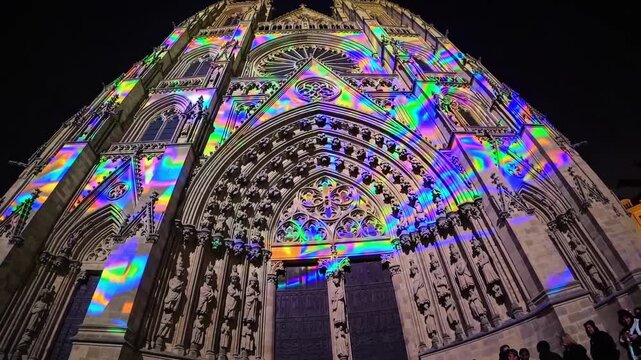 Nighttime Art Display. Urban Square Hosts Stunning Digital Art With Rainbow Projections. Evening Spectacle Features Immersive Digital Visuals Transforming Cathedral Into Vibrant Rainbow Event