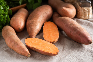 Group of uncooked sweet potatoes on wooden table background, Healthy vegetables harvest