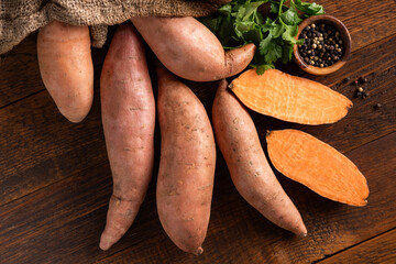 Group of uncooked sweet potatoes on wooden table background, Healthy vegetables harvest