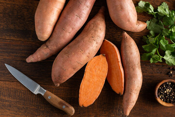 Group of uncooked sweet potatoes on wooden table background, Healthy vegetables harvest