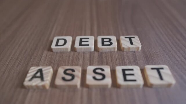 "Cinematic focus shifts between the wooden words DEBT and ASSET on a rustic background."