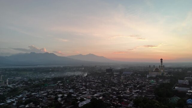 Aerial View of Mataram City at Sunrise with Mount Rinjani Silhouette