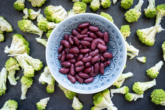 Healthy kidney beans with romanesco broccoli in bowl, top view