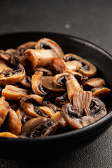 Fototapeta premium Champignon mushrooms ready to eat tasty snack fresh gourmet food background on the table rustic food top view copy space keto and paleo diet vegetarian and vegan food marketing concept photo