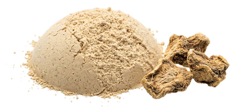 A fine heap of organic maca root powder presented alongside several dried raw maca root chunks isolated on transparent background