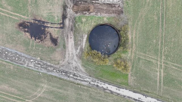 Manure storage tank lagoon pit submerged slurry collect and store liquid livestock pollution contamination groundwater solid waste bedding straw or corn stalks stored pile stinking unpleasant smell