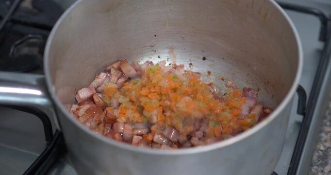 Italian Soffritto with Pancetta, Carrot, Celery and Onion Cooking in Pan