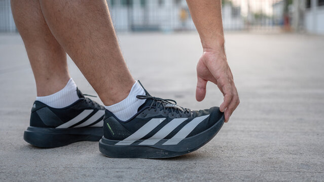 Bangkok, Thailand - 19 March 2026; A runner is wearing new Adidas Adizero Evo SL in black color way, this is the famous performance running racing shoe. Prepare for running on concrete floor.
