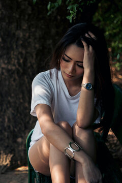 Vertical Horizon Frustrated Upset woman sit green park loneliness. Heartbroken Women worried make mistake negative emotion panic hurt feeling depression. Vertical Women regret sad crying life crisis