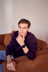 Obraz premium portrait of an attractive young 20 year old man with dark hair and blue eyes, studio photo shoot