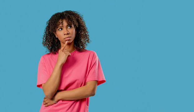 Thoughtful Around African Teen school student girl, Weighing Options, dreaming about future. Puzzled Lady Looking Answer