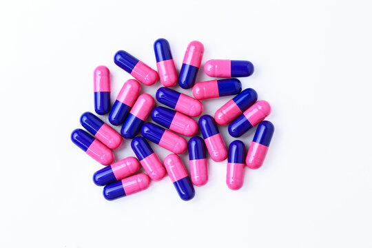 Close-up of omeprazole gastro-resistant capsules (proton pump inhibitor) on white background for gastrointestinal treatment