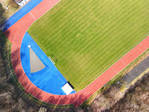 Aerial View of Sports Facility with Running Track and Multi-Sport Courts	
