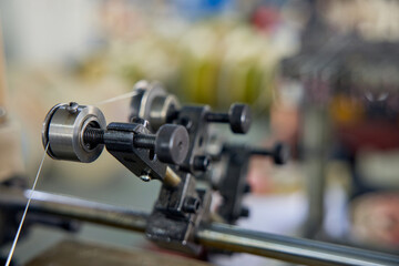 Fototapeta premium Industrial Lathe Equipment with Cable in Manufacturing Workshop
