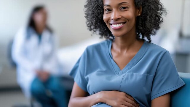 Joyful expectant mother at prenatal appointment with supportive healthcare professional