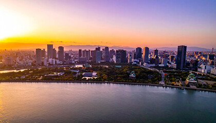 Fototapeta premium Osaka bay view of city skyline and castle at sunset