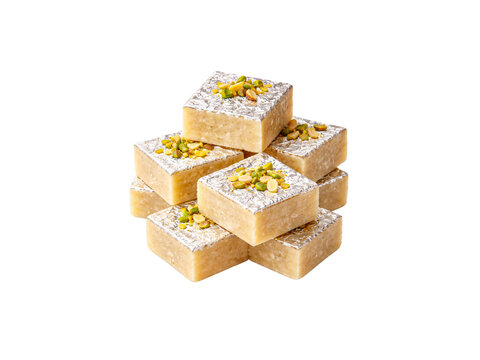 Traditional indian barfi sweet with pistachios and silver leaf (varak) isolated on white background.