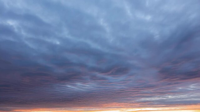 Clouds at sunset with pink and orange hues in the sky featuring nature, landscape, atmosphere with twilight and dawn elements for dusk, cloudscape