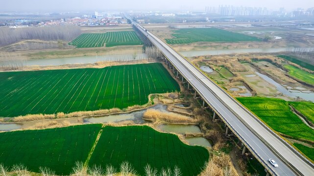 Aerial Highway Bridge Over Rural Agricultural Fields and Wetlands