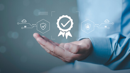 Cybersecurity compliance, trust verification, data protection, and enterprise digital safety. Businessman holding digital quality certification badge, security shield and cloud protection icons © Krittamet