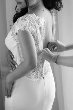 preparations for the bride with the dressing of the wedding dress