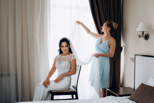 preparations for the bride with the dressing of the wedding dress