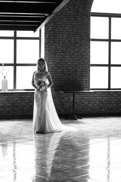 portrait of a young bride inside a restaurant agains