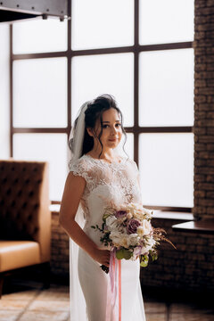 portrait of a young bride inside a restaurant agains
