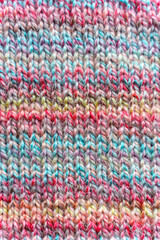 Fototapeta premium Close-up Texture of Handmade Knitted Clothing with Colorful Yarn Patterns