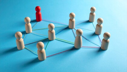Obraz premium Conceptual leadership network visualization with wooden figures on blue surface.