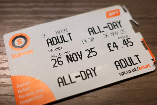 Glasgow Scotland: 31 12 2025: A person holds a Glasgow Subway smart ticket that allows all-day travel for adults. The ticket shows the issue time and price