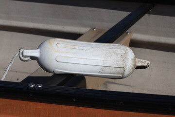 well-used white plastic boating, fishing float or bumper in sunshine (macro, close-up) © Don Hoskins