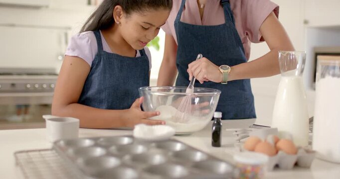 Mom guiding whisking, child holding bowl reaching for whisk, animated baking labels guiding hands
