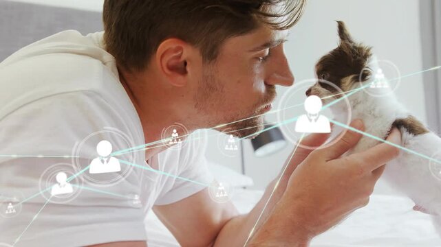 Man holding puppy and leaning in seeking gaze causing icons tech web layering across faces