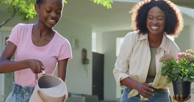 African American female mother and child guiding pot while child tipping watering can watering lawn