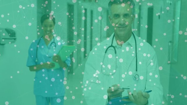 Cam zooming in showing doctor writing as nurse reading chart for care, green health orbs tinting