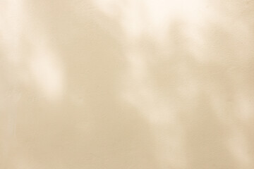 Fototapeta premium close up on beige plain wall background texture with shadow of window from sunlight for ads and advertisement product such as cosmetic or content or goods design display concept