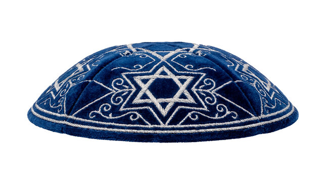 A detailed image of a blue kippah with a Star of David and detailed embroidered patterns. It's a symbol of Jewish faith and tradition