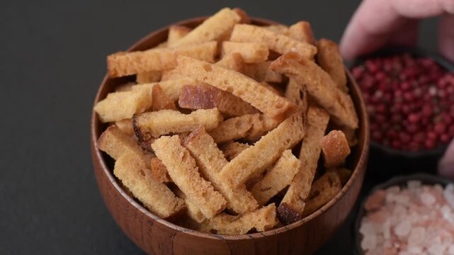 Croutons or crackers made from rye bread with garlic, salt, and spices, a salad ingredient. Croutons with salt and garlic as a food background for your design