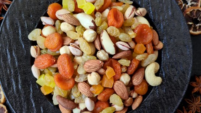 A mix of nuts and dried fruits as ingredients for a healthy meal. Nuts and dried fruits as a food background for your design