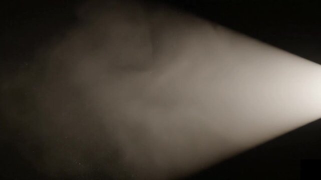 soft smoke cloud spreading on dark background showing cinematic fog effect for atmospheric visuals, mystery scenes and visual effects compositing