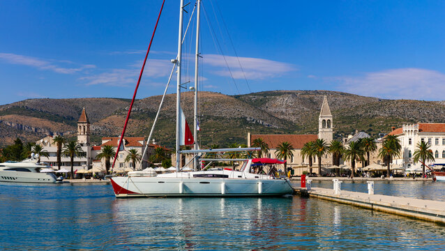 Trogir Croatia panorama of old town skyline and luxury white yachts. Scenic waterfront view of Venetian towers and medieval city from opposite coast. UNESCO heritage and nautical travel in Dalmatia