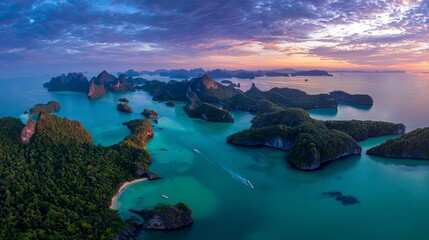 Vacationers enjoy a stunning sunset over Hong island and Phang Nga Bay in Thailand. Turquoise waters shimmer below, viewed from above.