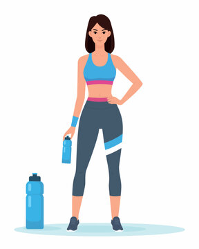 Fit Young Woman Standing With Water Bottle After Workout in Athletic Clothing and Sneakers