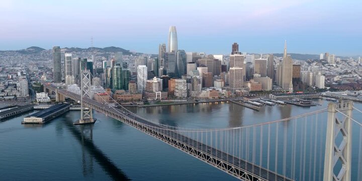 San Francisco - High Aerial Shot of Downtown SF Over Bay Bridge at Dawn with Early Morning Light and Light Traffic on Bridge