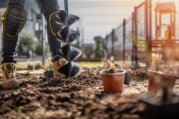 Detail of hand-held soil hole drilling machine or portable manual cordless earth auger for prepare the soil for planting plants. © Peter