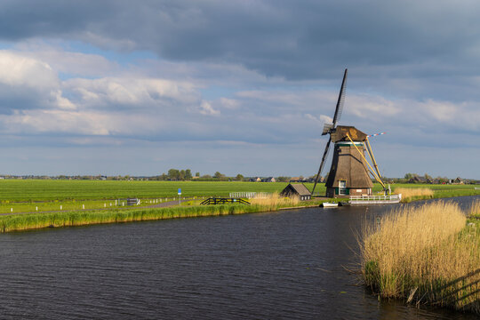 Traditional Dutch windmill standing along a canal in Groot Ammers