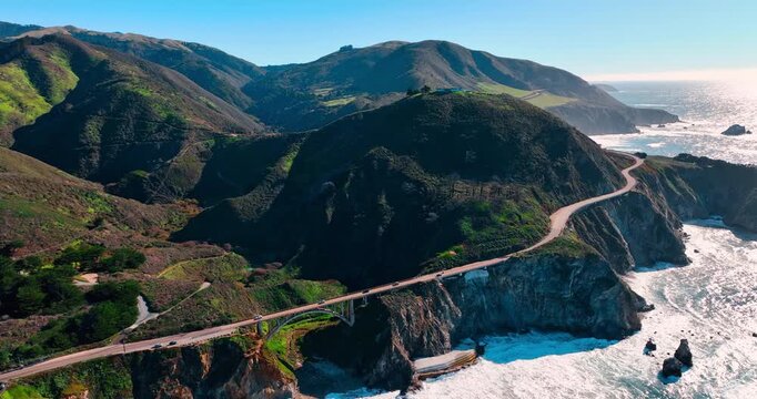 Aerial view of Bixby Creek Bridge on Highway 1 California. Drone shot of concrete arch bridge and coastal mountains along Big Sur Pacific coast