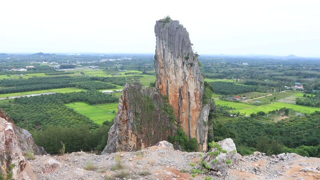 Natural video background of a high-angle atmosphere on a mountain that overlooks the surrounding scenery(mountains, trees,sea)from a scenic vantage point,with a wooden chair for sitting and resting