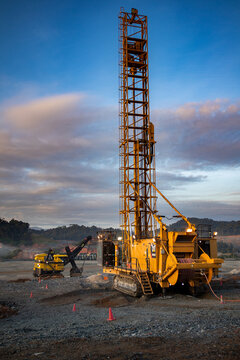 Blast hole rotary drill operating in a modern open-pit mine, illustrating precision drilling under strict safety protocols and well-managed work zones.The scene emphasizes responsible mining practiceS
